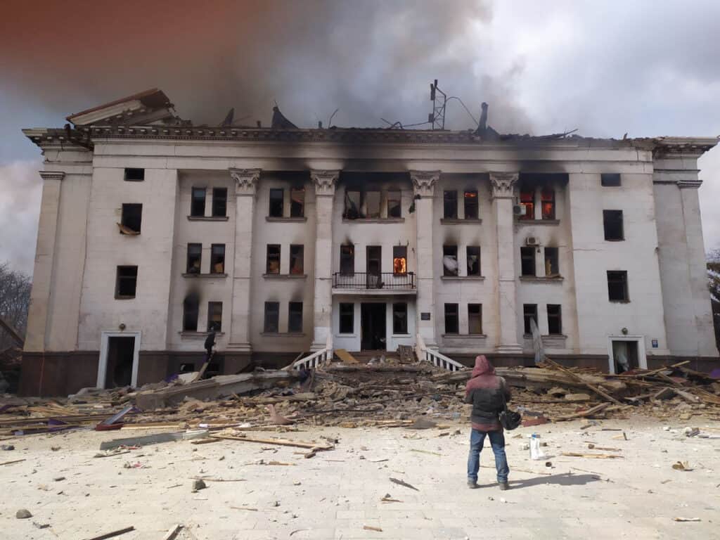 Serhii Zabohonskyi, an actor who used to perform at the theatre and a survivor of the attack, stands outside the rear of the theatre moments after the explosion.